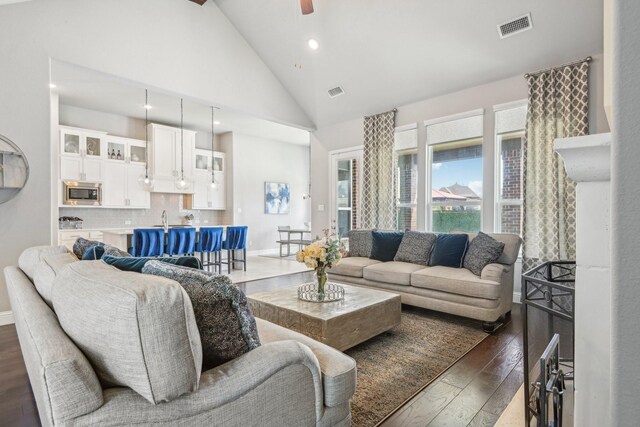 living room featuring ceiling fan, sink, high vaulted ceiling, and dark hardwood / wood-style floors