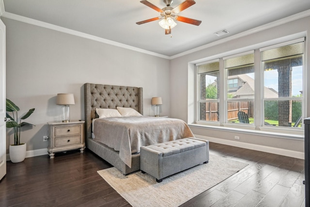 bedroom with multiple windows, ceiling fan, dark wood-type flooring, and ornamental molding