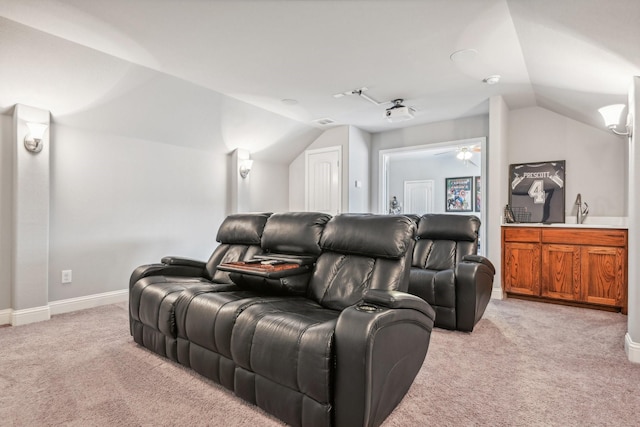 carpeted home theater room featuring ceiling fan, sink, and vaulted ceiling