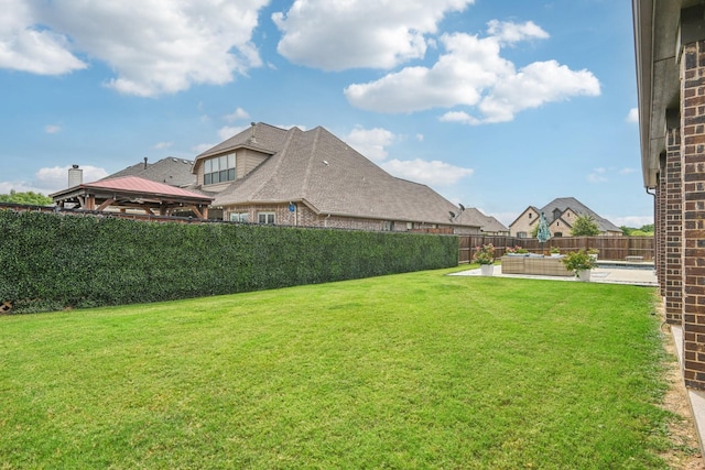 view of yard with a gazebo and a pool