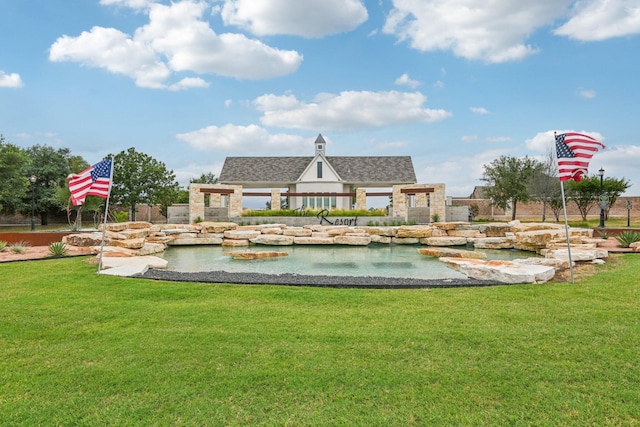 view of property's community with a lawn