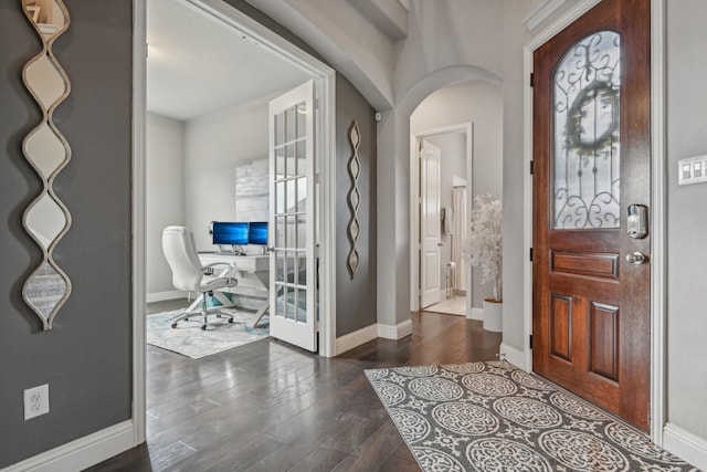 foyer with a healthy amount of sunlight and dark hardwood / wood-style flooring