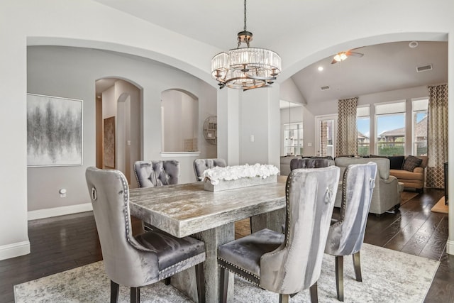 dining room featuring lofted ceiling, dark wood-type flooring, and ceiling fan with notable chandelier