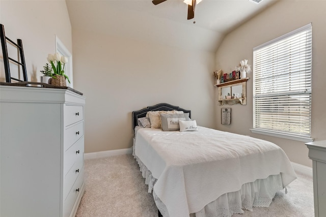 carpeted bedroom with ceiling fan and vaulted ceiling