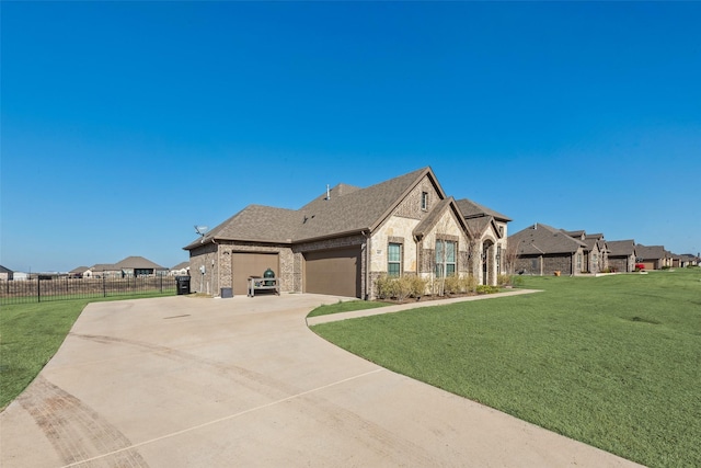 french country style house with a garage and a front yard