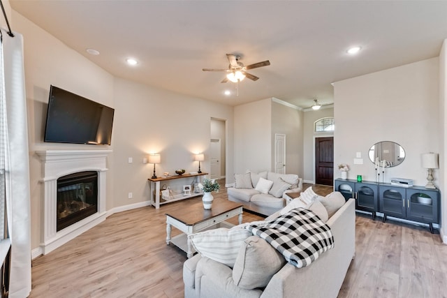 living room featuring ceiling fan and light wood-type flooring