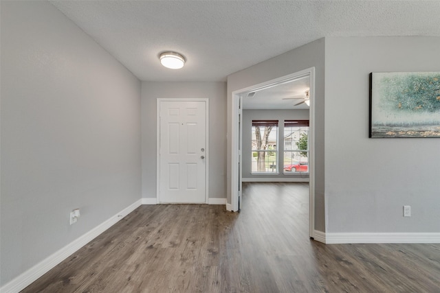 entryway with ceiling fan, hardwood / wood-style floors, and a textured ceiling