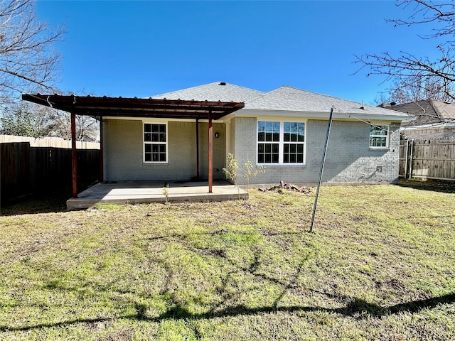 back of property with a lawn and a patio