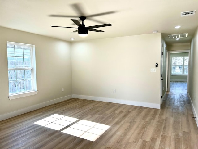 unfurnished room with ceiling fan and light wood-type flooring