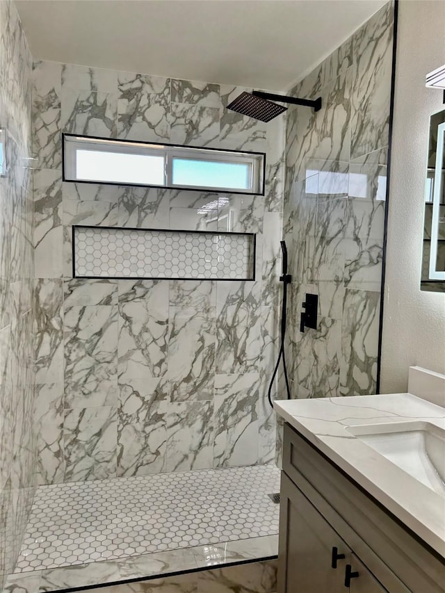 bathroom featuring vanity and tiled shower