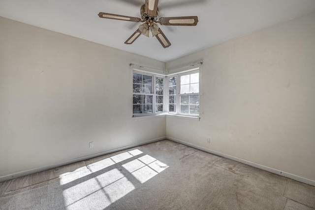 spare room featuring light carpet and ceiling fan