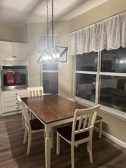 dining space featuring a chandelier and dark hardwood / wood-style floors