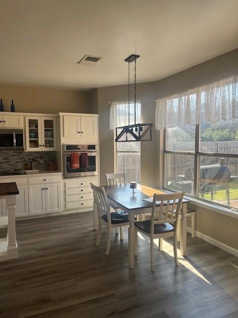 dining space with dark wood-type flooring