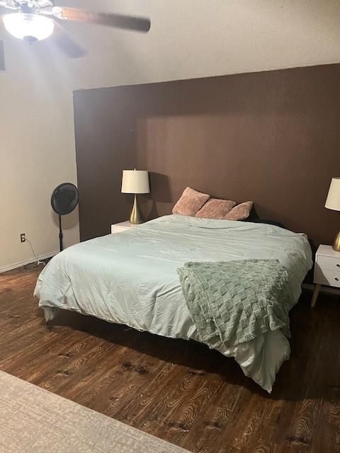 bedroom featuring dark hardwood / wood-style floors and ceiling fan