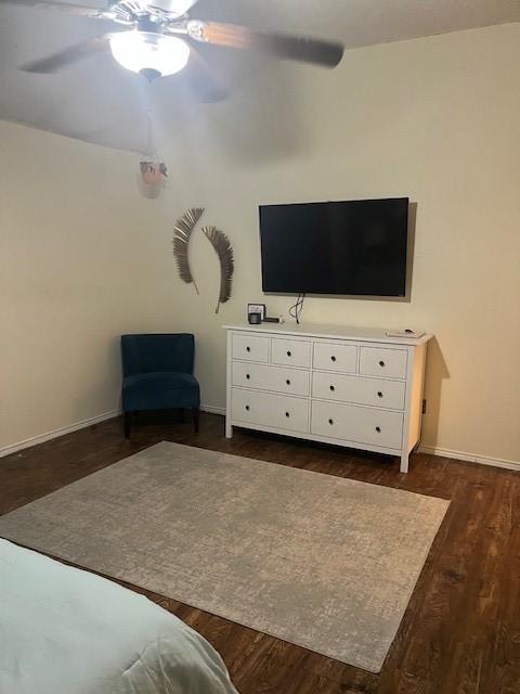 bedroom with ceiling fan and dark hardwood / wood-style floors