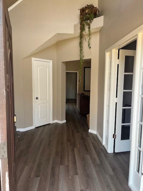 corridor with dark hardwood / wood-style floors