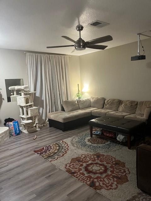 living room with hardwood / wood-style floors and ceiling fan