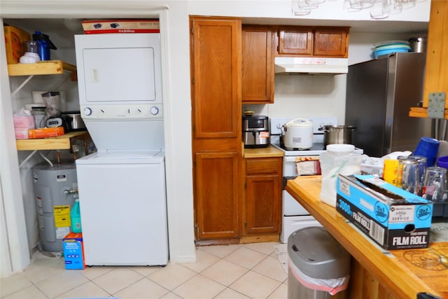 kitchen with stainless steel refrigerator, stacked washer / dryer, water heater, and light tile patterned flooring