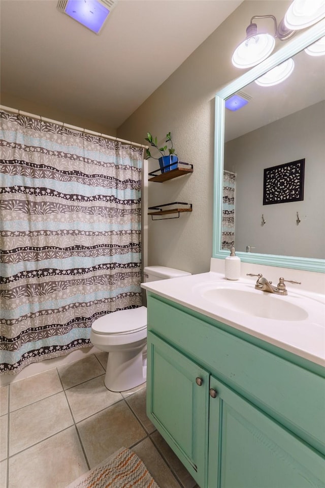 bathroom featuring tile patterned floors, vanity, and toilet