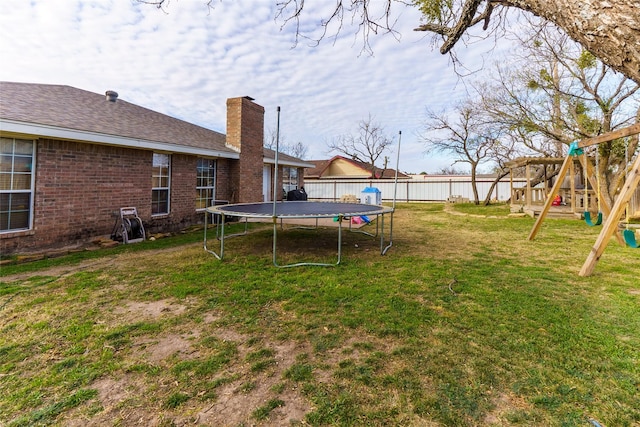 view of yard featuring a playground and a trampoline