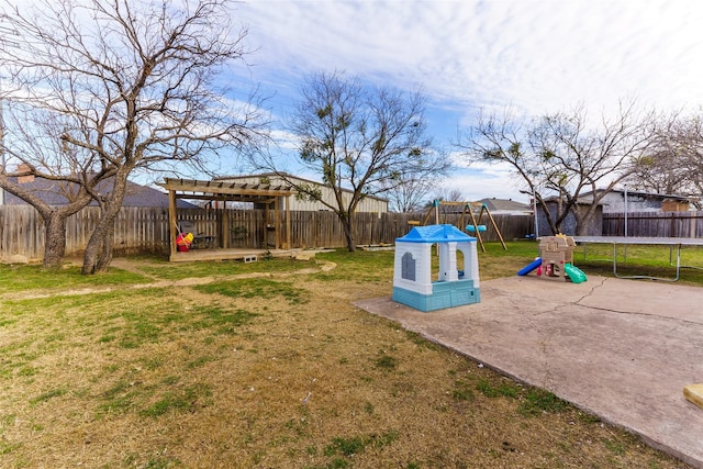 view of yard with a playground and a trampoline