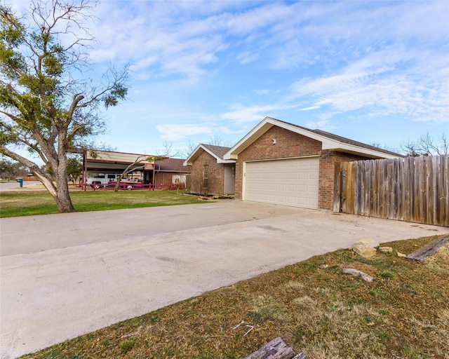 view of front of house featuring a garage and a front lawn