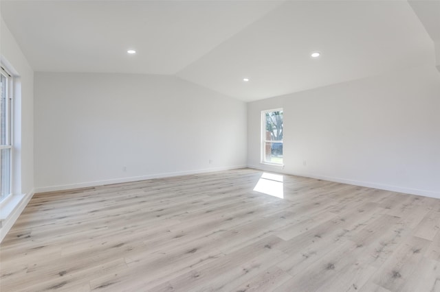 unfurnished room featuring vaulted ceiling and light wood-type flooring