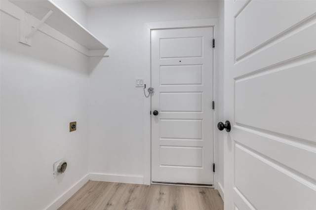 washroom featuring electric dryer hookup and light hardwood / wood-style floors