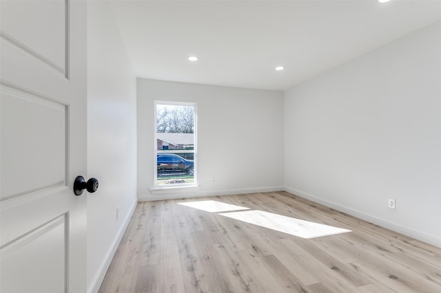 empty room with light hardwood / wood-style flooring