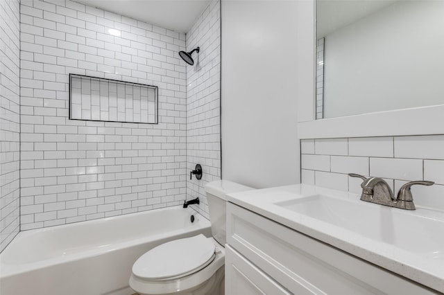 full bathroom with tiled shower / bath combo, toilet, vanity, and tasteful backsplash