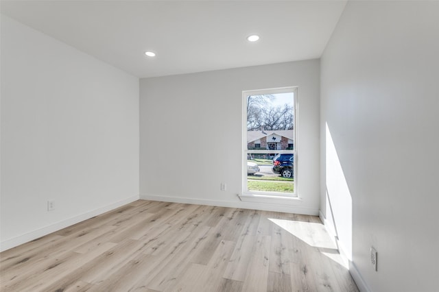 empty room with light wood-type flooring and a wealth of natural light