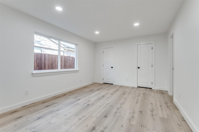 unfurnished bedroom featuring light wood-type flooring