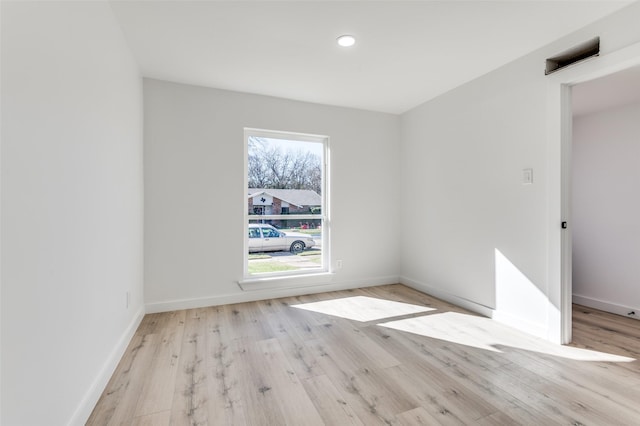 unfurnished room featuring light hardwood / wood-style floors