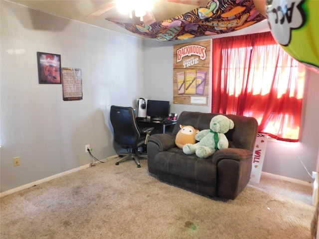 carpeted office space featuring ceiling fan