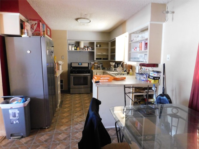 kitchen with sink, white cabinets, a textured ceiling, and appliances with stainless steel finishes