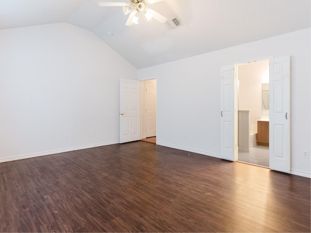 unfurnished bedroom featuring dark hardwood / wood-style flooring, ensuite bath, vaulted ceiling, and ceiling fan