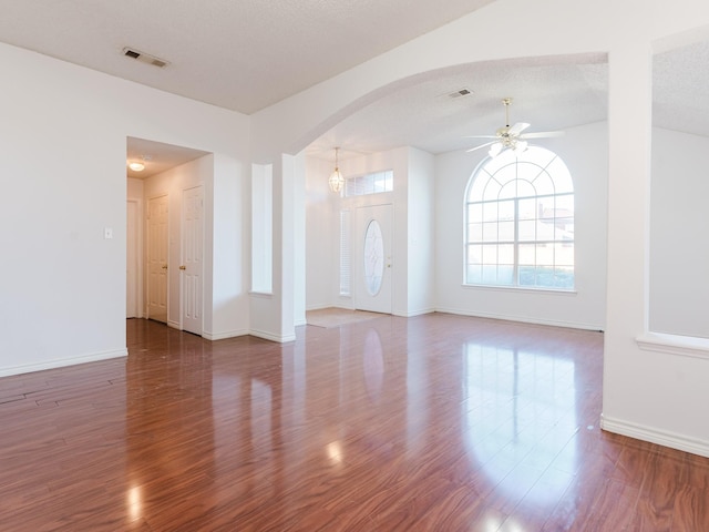 interior space featuring ceiling fan, a textured ceiling, and hardwood / wood-style flooring