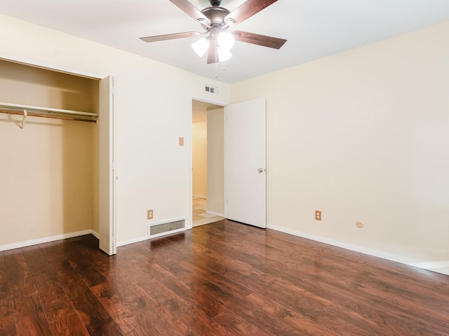 unfurnished bedroom with dark hardwood / wood-style floors, ceiling fan, and a closet