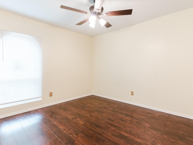 empty room featuring dark wood-type flooring and ceiling fan