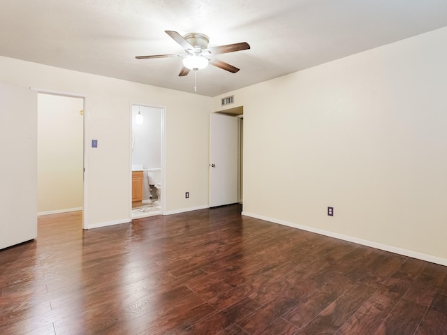 spare room featuring dark hardwood / wood-style flooring and ceiling fan