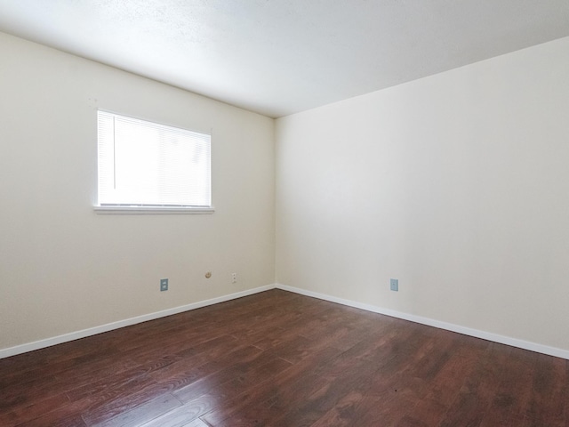 empty room with dark hardwood / wood-style floors