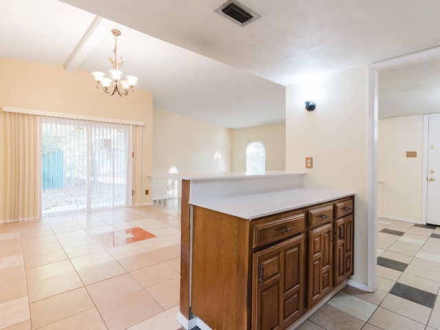 kitchen featuring an inviting chandelier, decorative light fixtures, beamed ceiling, and light tile patterned flooring