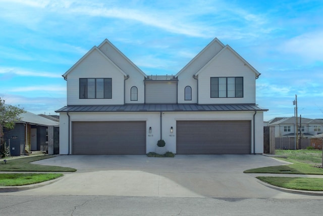 modern farmhouse with a garage and a front lawn