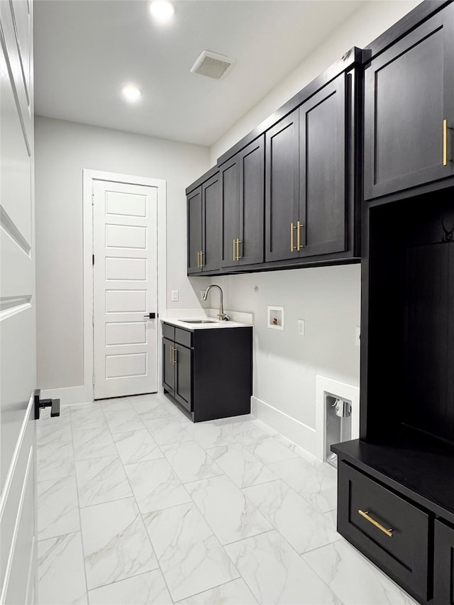 clothes washing area with cabinets, sink, and hookup for a washing machine