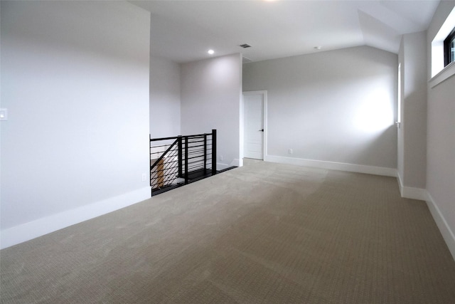 empty room with carpet and lofted ceiling