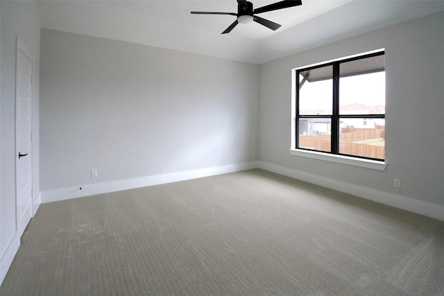 carpeted empty room featuring ceiling fan