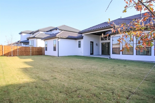 rear view of house featuring a lawn