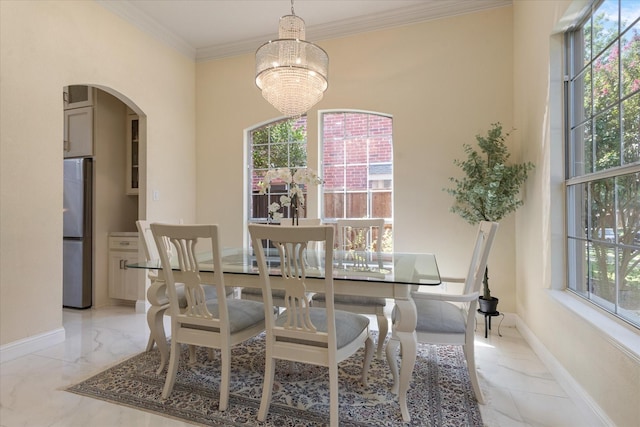 dining space featuring arched walkways, a notable chandelier, baseboards, marble finish floor, and crown molding