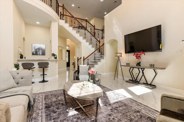 kitchen with sink, stainless steel appliances, light stone counters, backsplash, and white cabinets