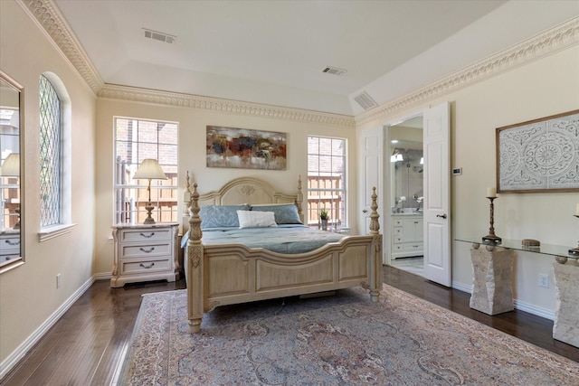 bedroom featuring lofted ceiling, ensuite bathroom, crown molding, and dark hardwood / wood-style floors